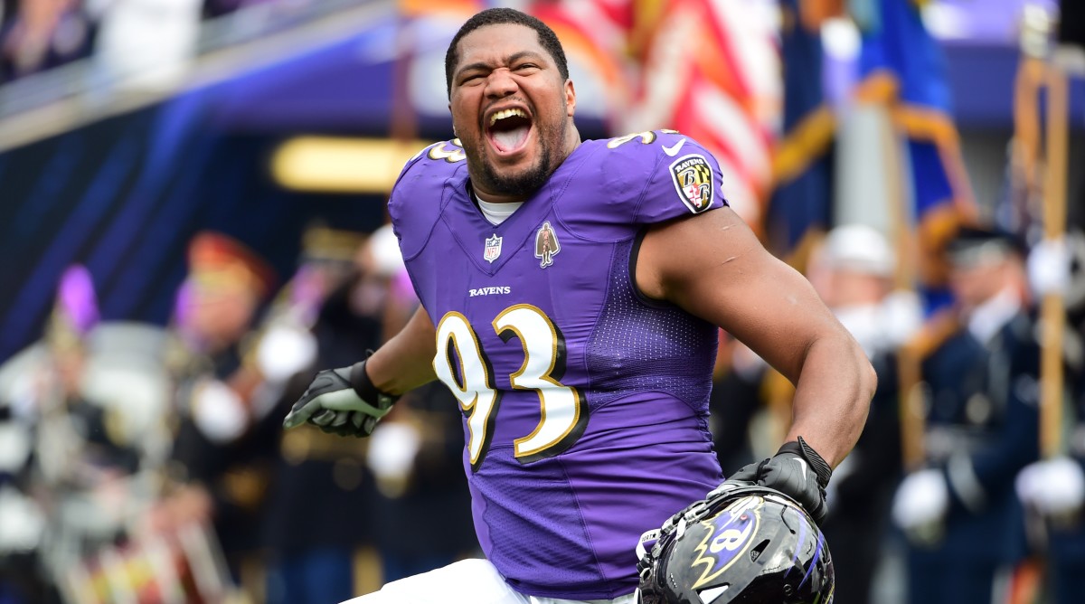 Calais Campbell runs onto the field before a game.